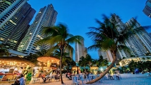 A beachside hotel with high-rise buildings, palm trees, and outdoor seating areas. - Full Sea View Country Garden Danga Bay 11-13pax (Johor Bahru)