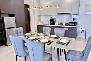 A modern kitchen with a dining area.