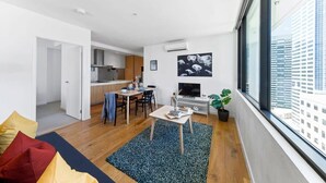 A modern apartment with a kitchen, dining area, and living room. - A Chic 2BR Apt, City Views Near Southern Cross (Melbourne)