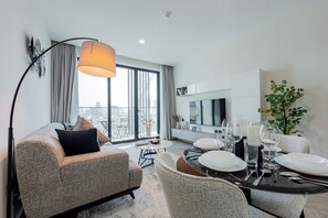 Deluxe Apartment, Balcony, City View | Living area | 55-inch Smart TV with digital channels