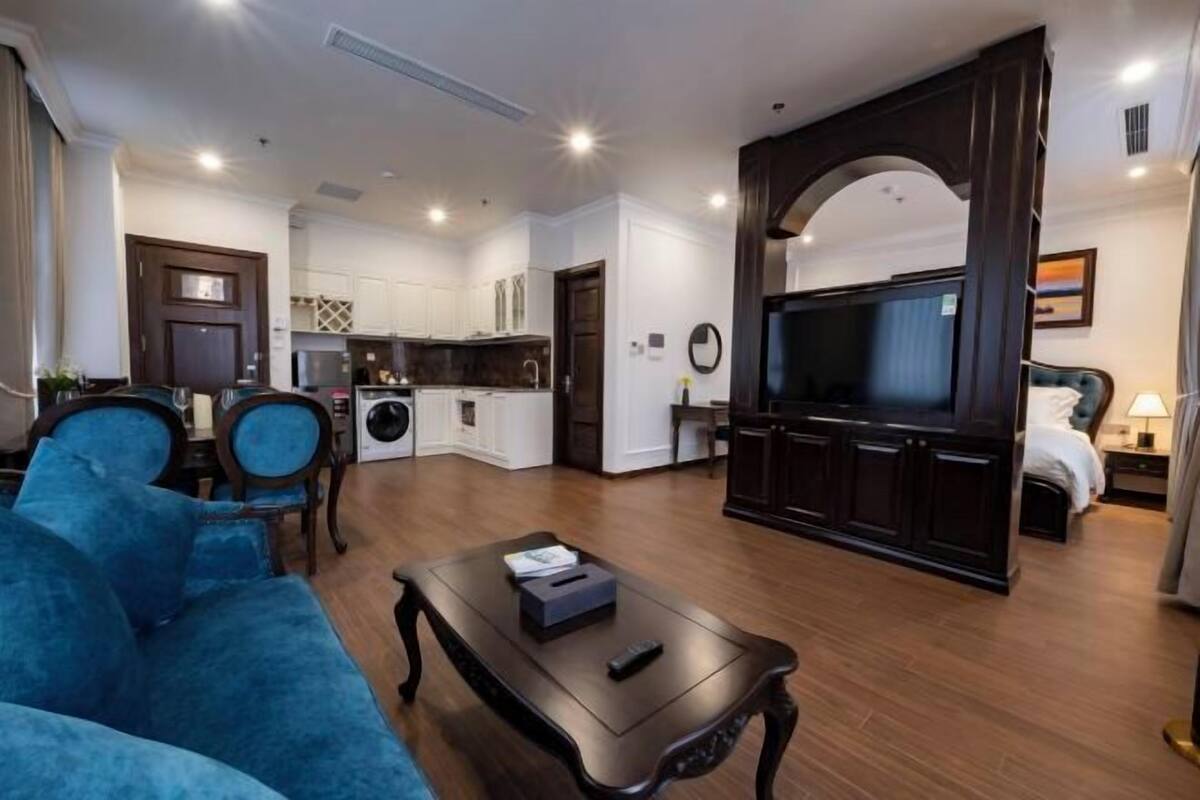 A modern living room with a sofa, coffee table, and a TV.