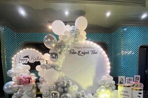 A birthday celebration setup with a balloon arch and a sign that reads 'Happy Birthday Tran Quynh Tam'. - MADELISE HOTEL&APARTMENT (Haiphong)