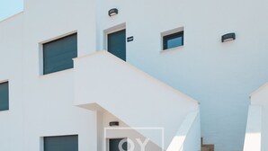 A modern residential building with a staircase leading to the upper floor. - Nalia Horizon Penthouse, Outdoor living with solarium, BBQ, pool, hot tub - by OYOOSTAYS (Torrevieja)