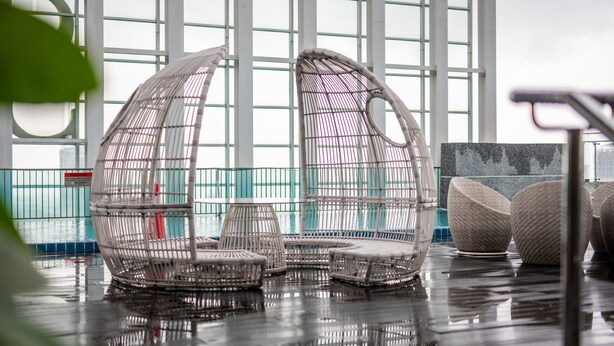 A modern indoor space with transparent, dome-shaped seating areas and a large windowed wall. - A Lovely & Comfy Suite at Suasana Suites JB 11 (Johor Bahru)
