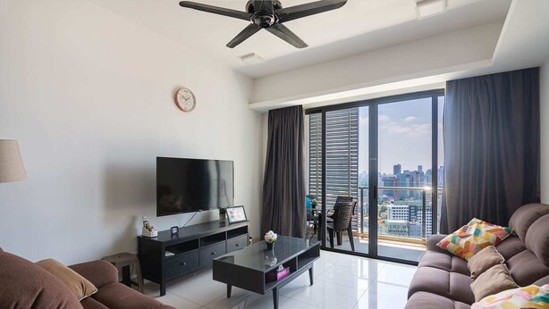 A modern living room with a flat-screen TV, a ceiling fan, and a large window with curtains. - A Stylish High Floor 3BR Apt at Bukit Bintang (Kuala Lumpur)