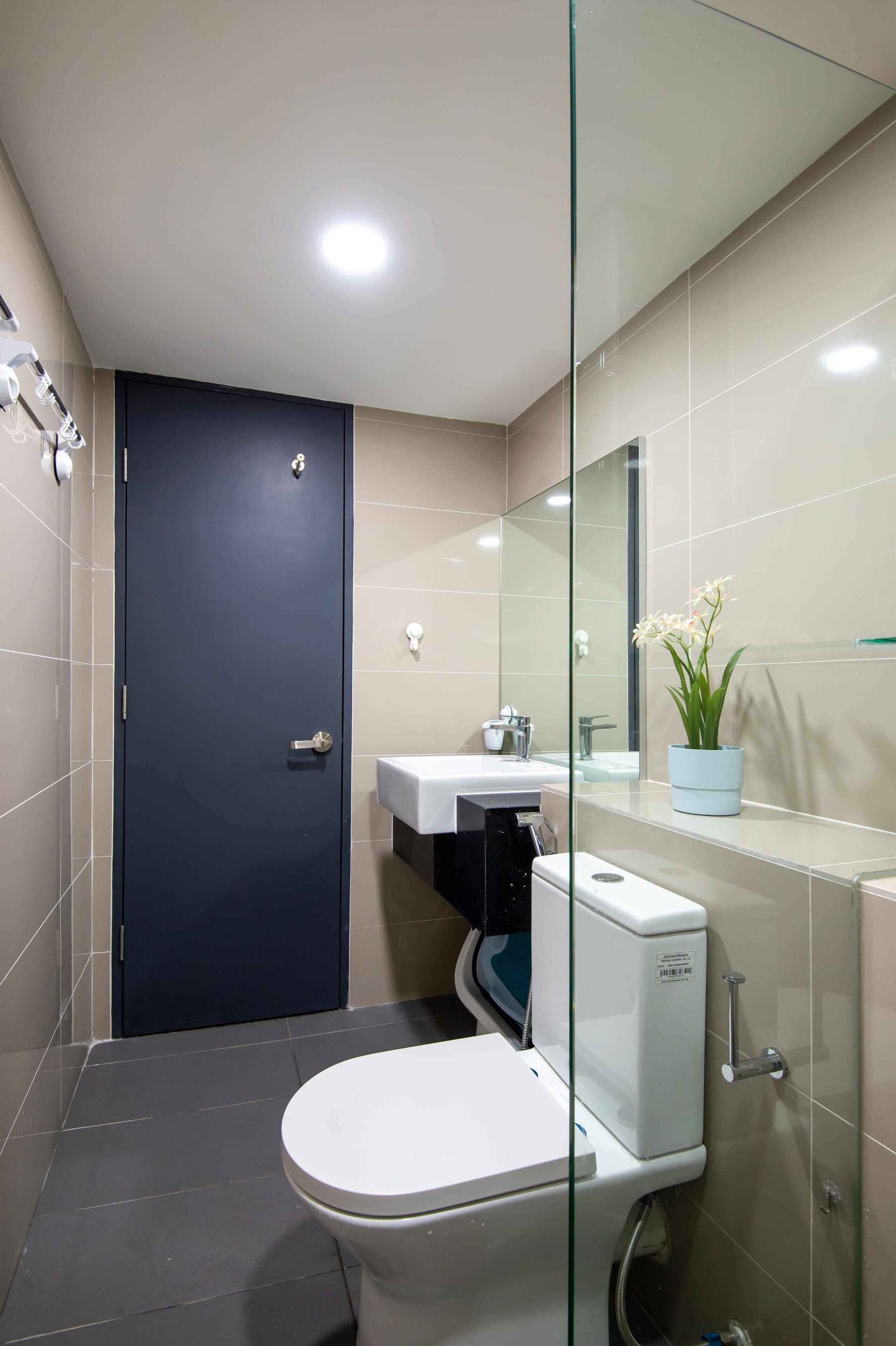 Un baño moderno con inodoro, lavabo y cabina de ducha de vidrio.