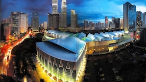 A modern building with a curved roof and a large open space in front. - A Stylish 2BR Home, 5min Walk to Klcc (Kuala Lumpur)