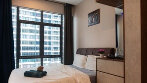 A hotel room with a large window, a bed with white linens, a dresser, and a painting on the wall. - 3BR Lsh33 KL Duke Highway Genting Free parking (Kuala Lumpur)