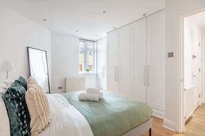 1 bedroom, desk, iron/ironing board, travel crib