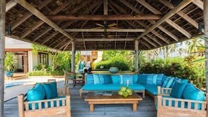 An outdoor seating area with wooden furniture and a thatched roof. - Villa Waimarie | Lipa Noi Beachfront 6BR Villa — Pool & Chef (Surat Thani)
