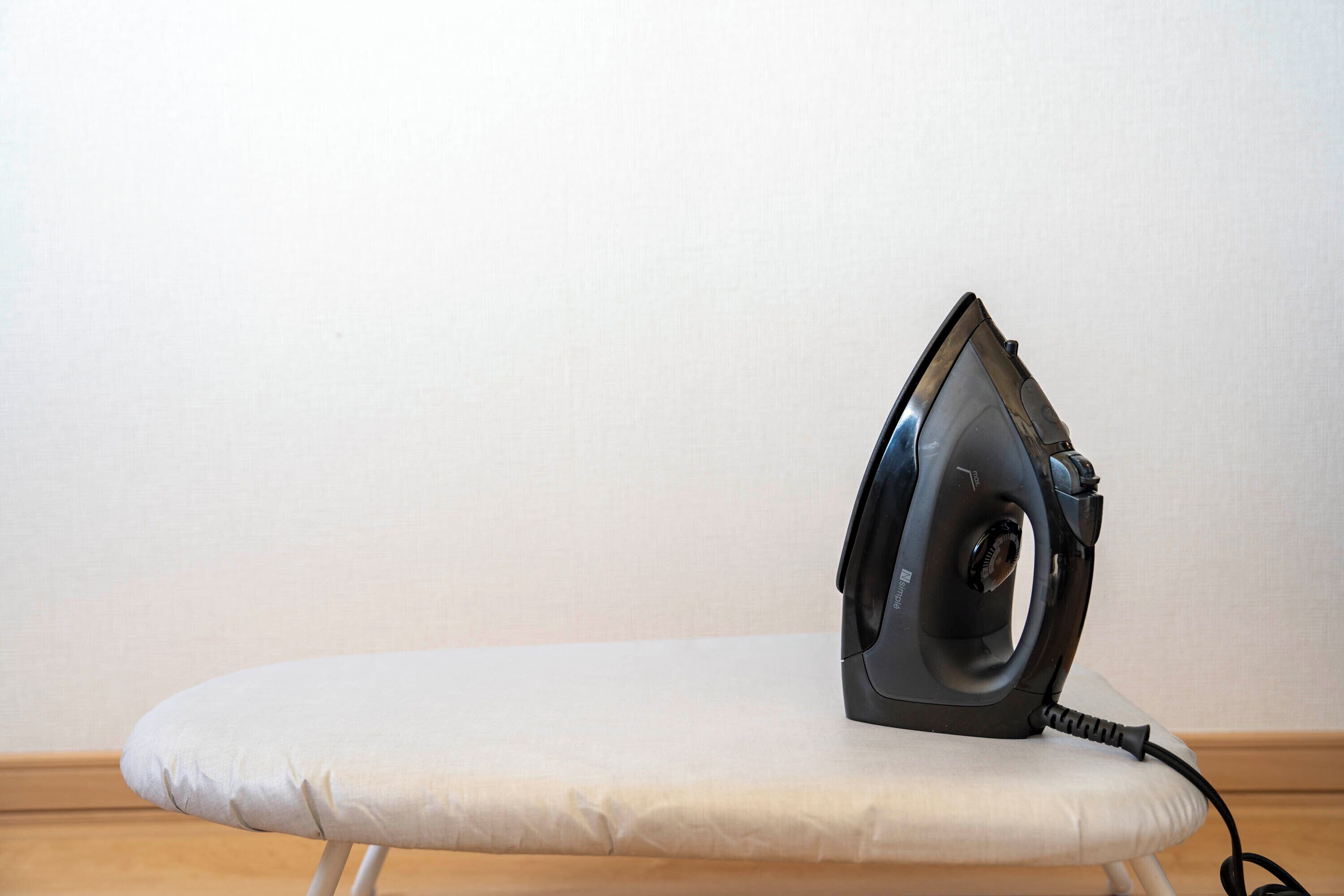 An ironing board with an iron placed on it.