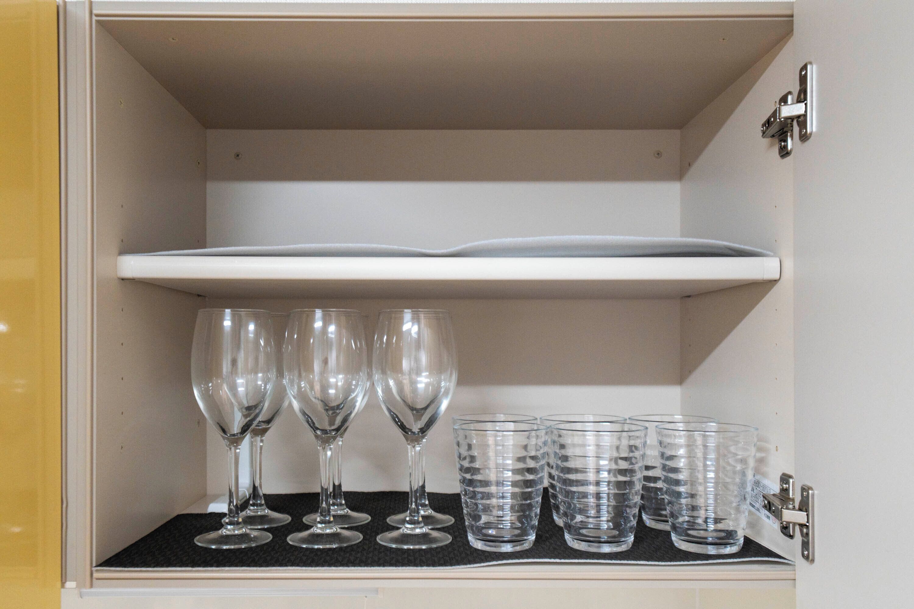 A cabinet with wine glasses and water glasses.