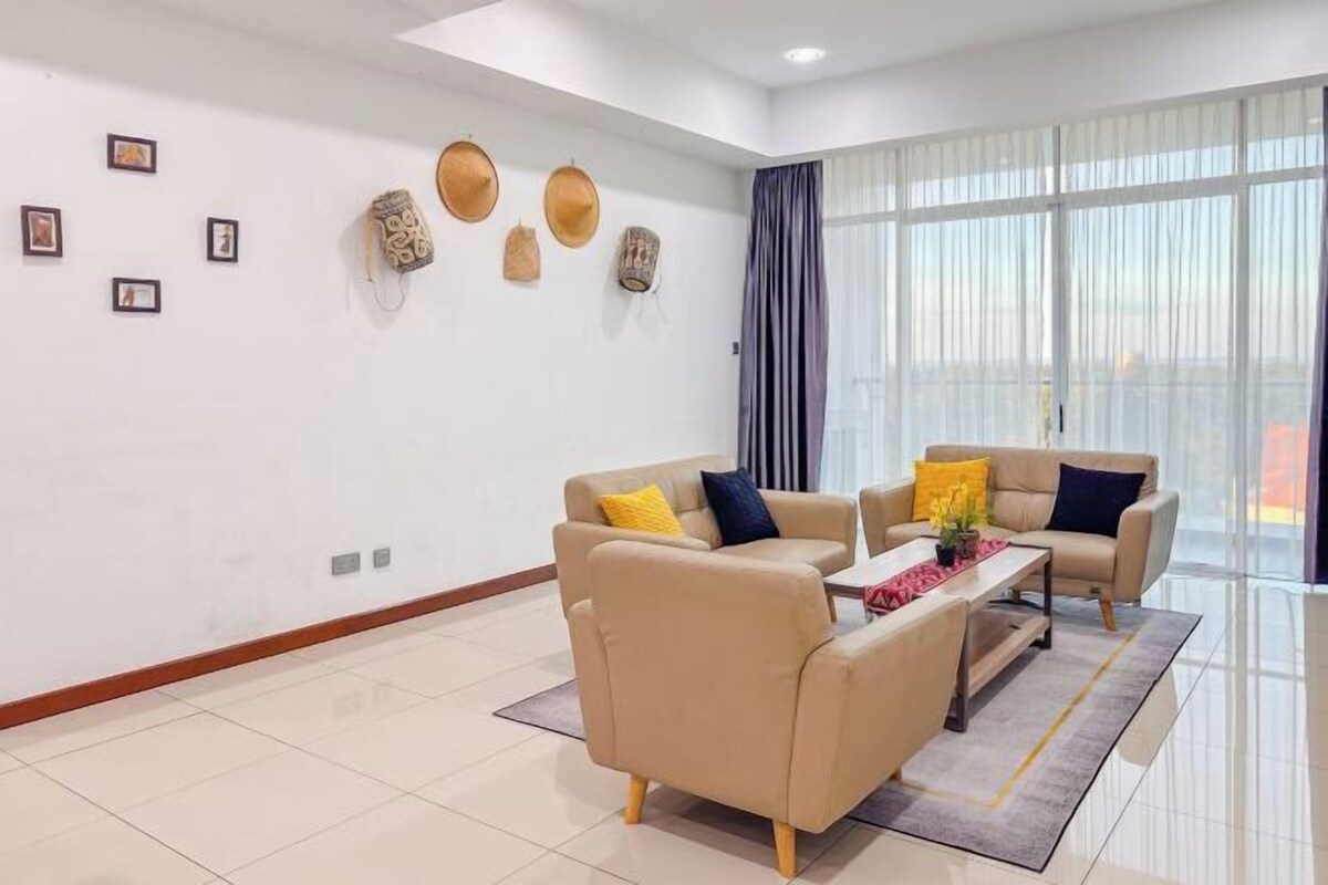 A modern living room with two sofas, a coffee table, and a large window with curtains.