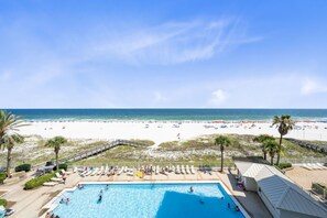 A pool area with a view of the beach and ocean. - Pelican Pointe by Hosteeva (Orange Beach)