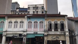 A row of traditional buildings with shop fronts, including a visible sign for 'Timothy's'. - Mingle Highstreet (Kuala Lumpur)