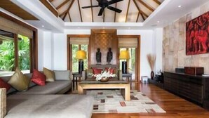 A spacious living room with a sofa, coffee table, and decorative items.