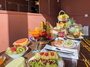 Un buffet de petit-déjeuner proposant une variété de fruits, de fromages et de sandwichs.
