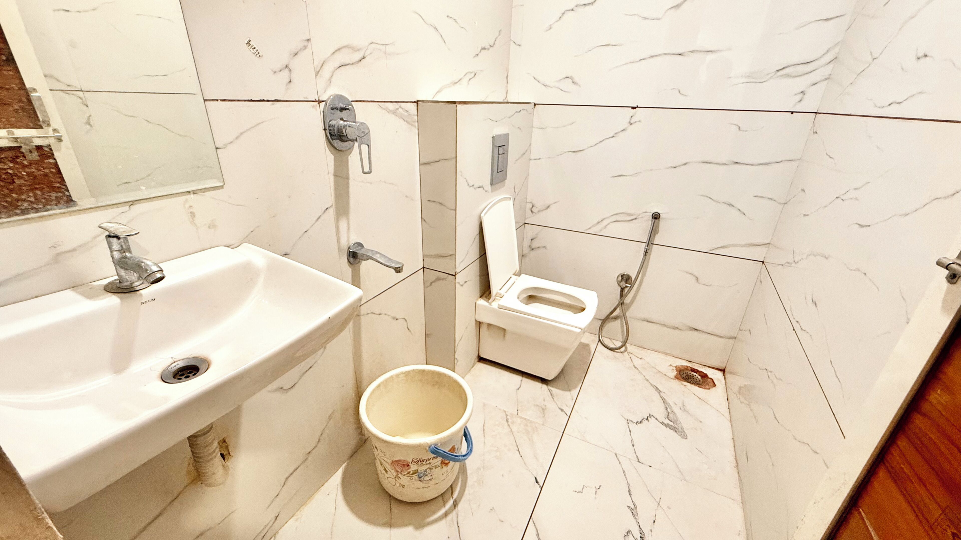 A bathroom with a sink, toilet, and shower.