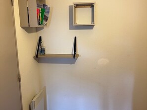 A wall-mounted shelf with a bottle of hand sanitizer and a small box. - Spacious apartment for 6 with terrace and private parking (Besse-et-Saint-Anastaise-Super Besse)