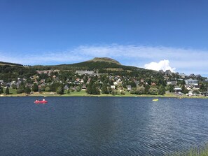 A lakeside view with houses and a mountain in the background. - Spacious apartment for 6 with terrace and private parking (Besse-et-Saint-Anastaise-Super Besse)