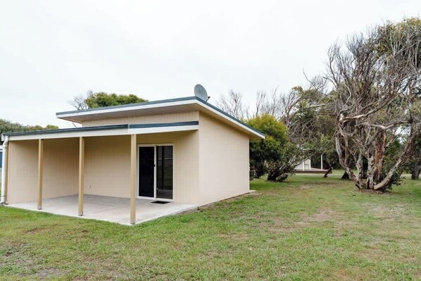 A single-story building with a flat roof, a covered porch, and a satellite dish. - Peterborough Serenity GOR (Peterborough)