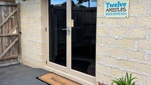 A stone building with a sign reading 'Twelve Apostles Beach House & Bar.'