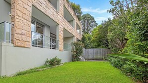A modern building with stone facade, large windows, and a well-maintained lawn. - Wonderful Warrawee with Parking and backyard (Warrawee)
