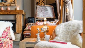 A cozy living room with a fireplace, a bookshelf, and a comfortable seating area. - Ready for renovation! | 4-minute walk to the ski lift | 10-minute walk to the wellness center/spa (Les Collons 1800m)