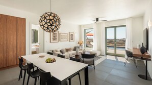 A modern living room with a dining area, a sofa set, and a view of the outdoors. - Ampelas 4BR Villa, Private Pool, To Ktima Paros (Paros)