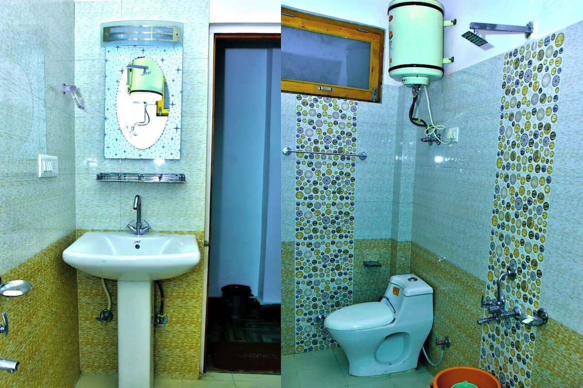 A bathroom with a sink, toilet, and shower.