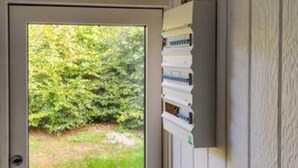 A door with a view of a green bushy area outside. - 4 Star Holiday Home in Hornbaek (Hornbaek)