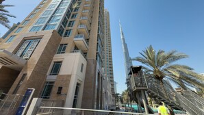 A tall building with a modern architectural design, featuring multiple balconies and large windows. -  Durrani Homes - Azure 2BR with Burj Khalifa and Fountain View (Dubai)