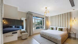 A modern bedroom with a large bed, a flat-screen TV, a bedside table, and a window with curtains. -  Durrani Homes - Azure 2BR with Burj Khalifa and Fountain View (Dubai)