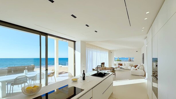 A modern kitchen with a large island, a dining area with a view of the ocean, and a living space with a sofa and a coffee table. - Solemar Sicilia - Villa Gloria (Ficarazzi)
