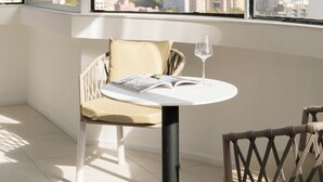 A modern room with a large window, a round table, and a chair. - Book and Bed - Xujiahui (Shanghai)