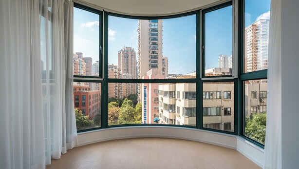 A room with large windows offering a view of high-rise buildings and a clear sky. - Book and Bed - Xujiahui (Shanghai)