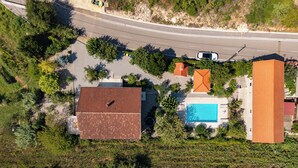 An aerial view of a residential area with a swimming pool, a road, and a large building with a red roof. - Holiday Home With Pool Near Makarsk (Proložac)