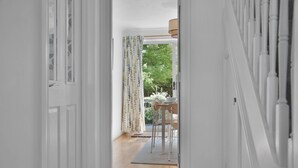 A hallway leading to a dining area with a view of greenery outside. - WhiskAwayHomes Pirie Avenue No. 2 (Worcestershire)