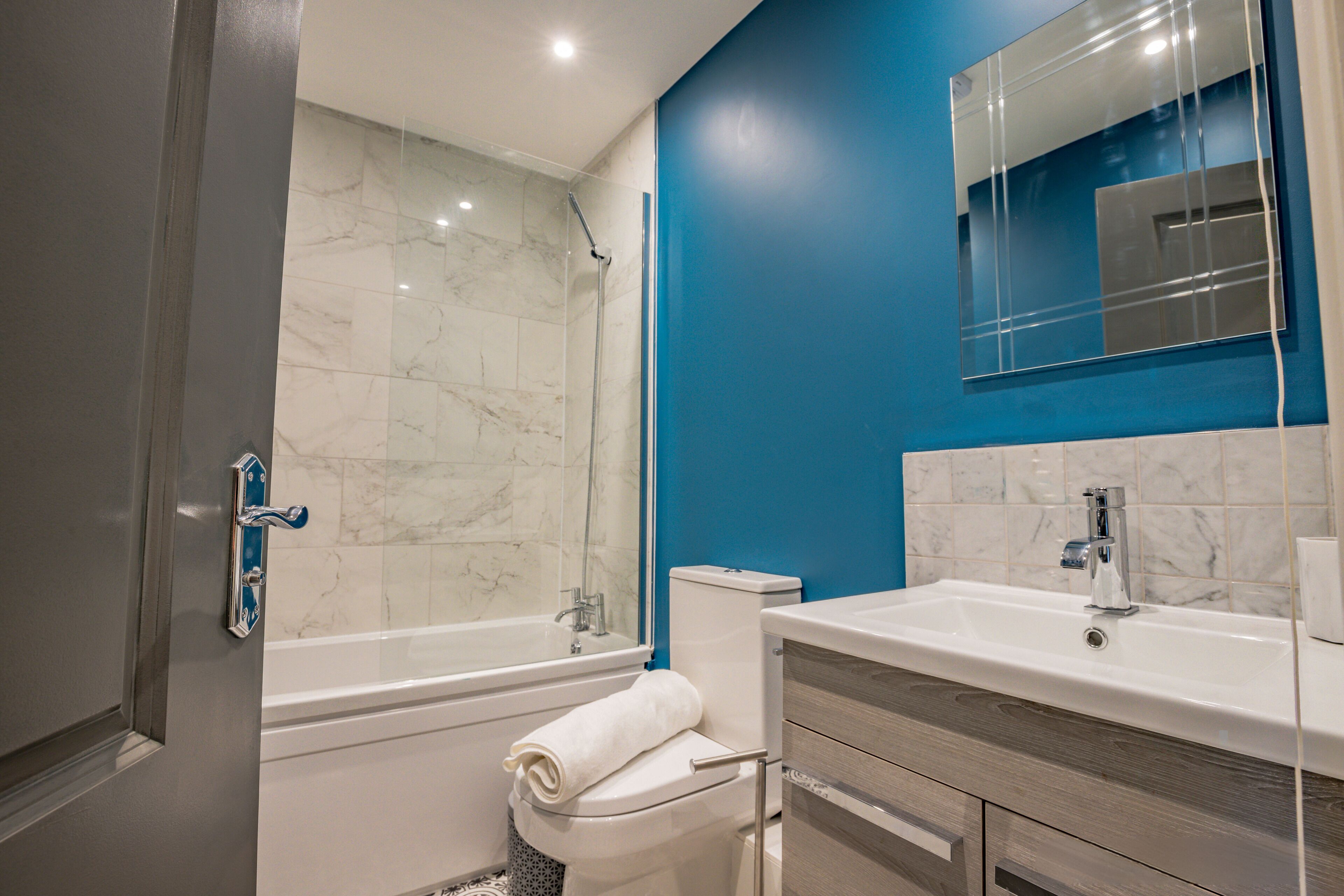 A bathroom with a bathtub, toilet, and sink.