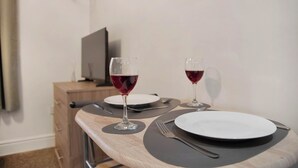 A dining table set with two wine glasses, plates, and cutlery. - WhiskAwayHomes Jenkins House Apartment 2 (Worcestershire)