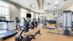 A gym with treadmills, elliptical machines, and weightlifting equipment. - Spacious Townhome 2 Mi to Bethany Beach Boardwalk (Frankford)
