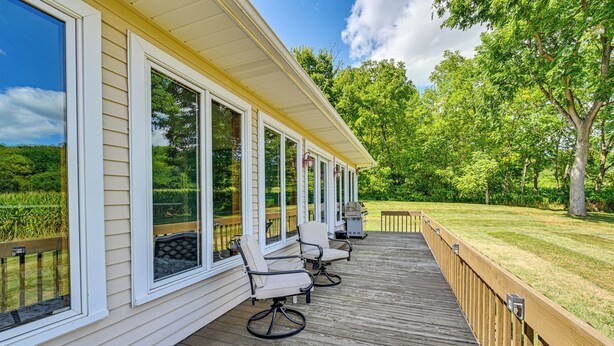A covered deck with outdoor seating and large windows overlooking a lush green landscape. - Rural & Private Dover Retreat: Close to Wineries! (Dover)
