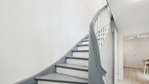 A staircase with a handrail and a landing area. - Haven of peace for people & dogs with terrace (Andernach)