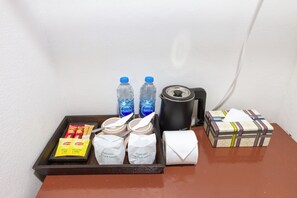 A tray with bottled water, a roll of toilet paper, a box of tissues, and two bags of hand sanitizer. - Le Panpurie Koh Lanta Resort (Ko Lanta)