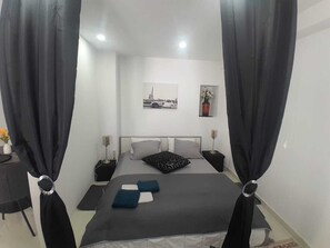 1 bedroom, desk, iron/ironing board, travel crib