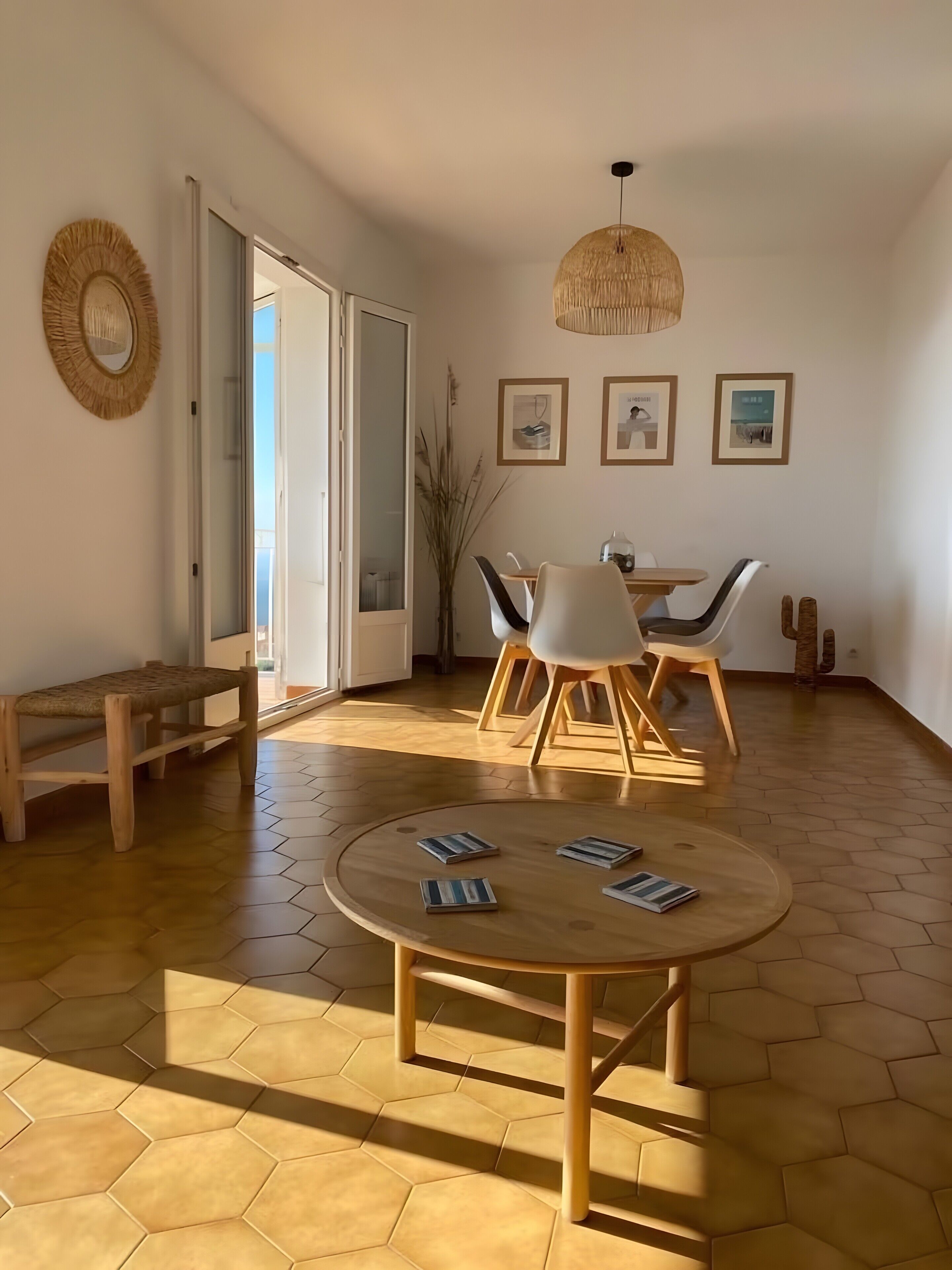 Een modern interieur met een ronde houten tafel, zeshoekig vloer en een eethoek met stoelen en een hanglamp.
