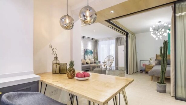 A modern living room with a dining area, featuring a wooden table, a sofa, and a large window. - Book and Bed - Lujiazui (Shanghai)