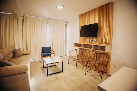 Deluxe Apartment, 1 Bedroom, Balcony, City View | Living area | 43-inch Smart TV with digital channels