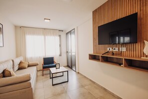 Deluxe Apartment, 1 Bedroom, Balcony, City View | Living area | 43-inch Smart TV with digital channels