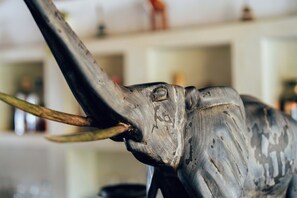 A close-up of a sculpture with a textured surface and a protruding horn. - Hekaya Zanzibar (Michamvi)
